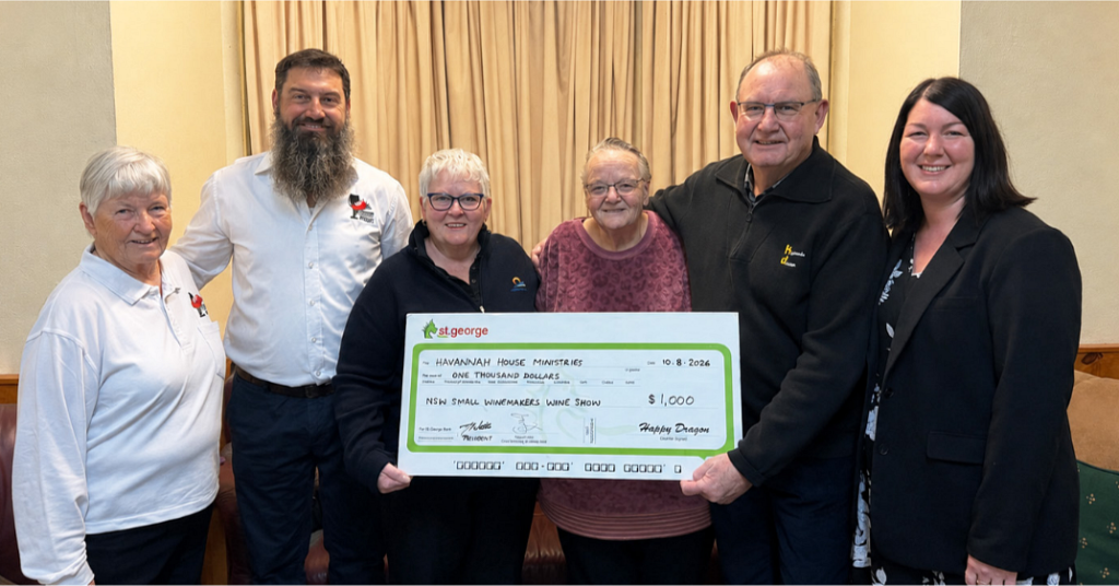 NSW Small Winemakers Wine Show committee members Judy Kerr, Scott Northey, Jenny Watts, Mark Watts and Amy Slessor presenting a $1,000 donation to Pastor Julie Virtue of Havannah House for their annual Christmas lunch.